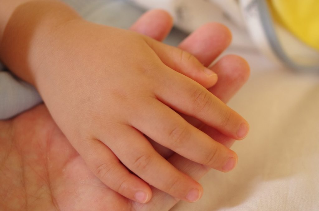 child holding parents hand, care and support