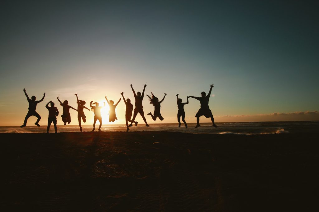 family jumping together, confident and happy